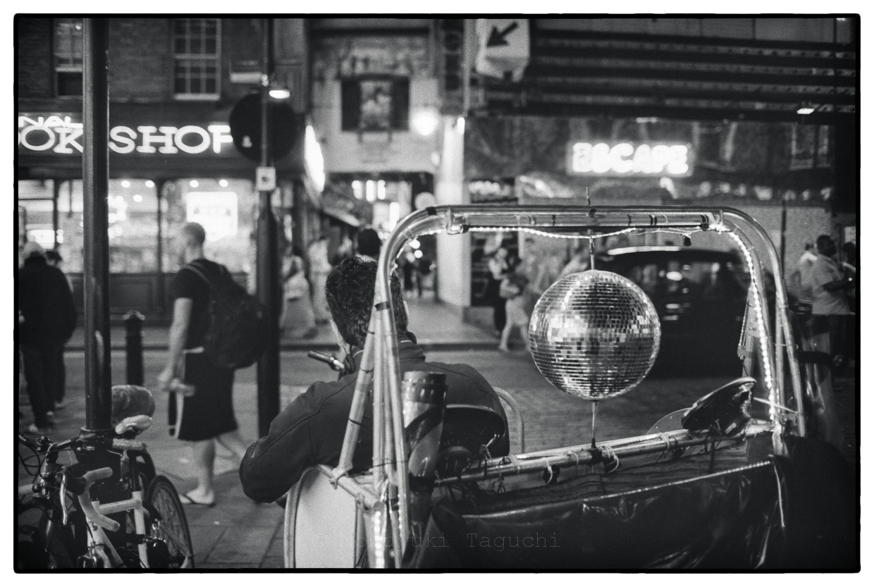 Street Photography London 2012 - London bicycle rickshaw with a mirror ball